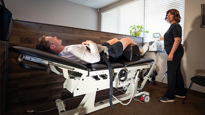 Chiropractic Assistant Pam With Patient On Spinal Decompression Table