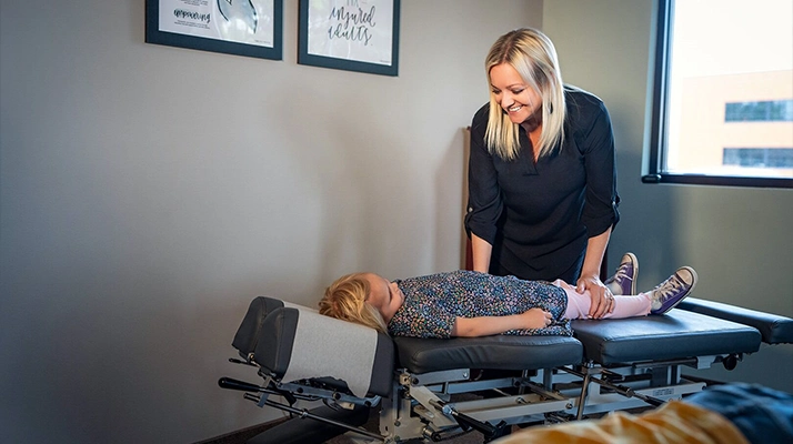 Chiropractor Andover MN Karrie Lehn Adjusting Pediatric Patient Chiropractor Karrie Lehn Adjusting Pediatric Patient