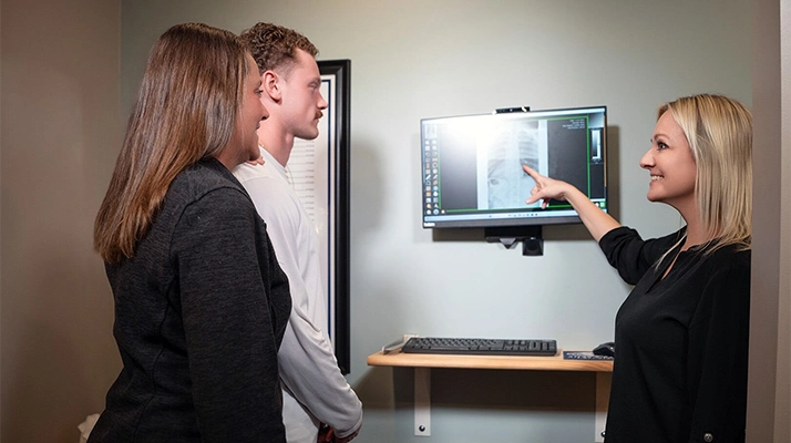 Chiropractor Andover MN Karrie Lehn Pointing To X-Ray Chiropractor Karrie Lehn Pointing To X-Ray
